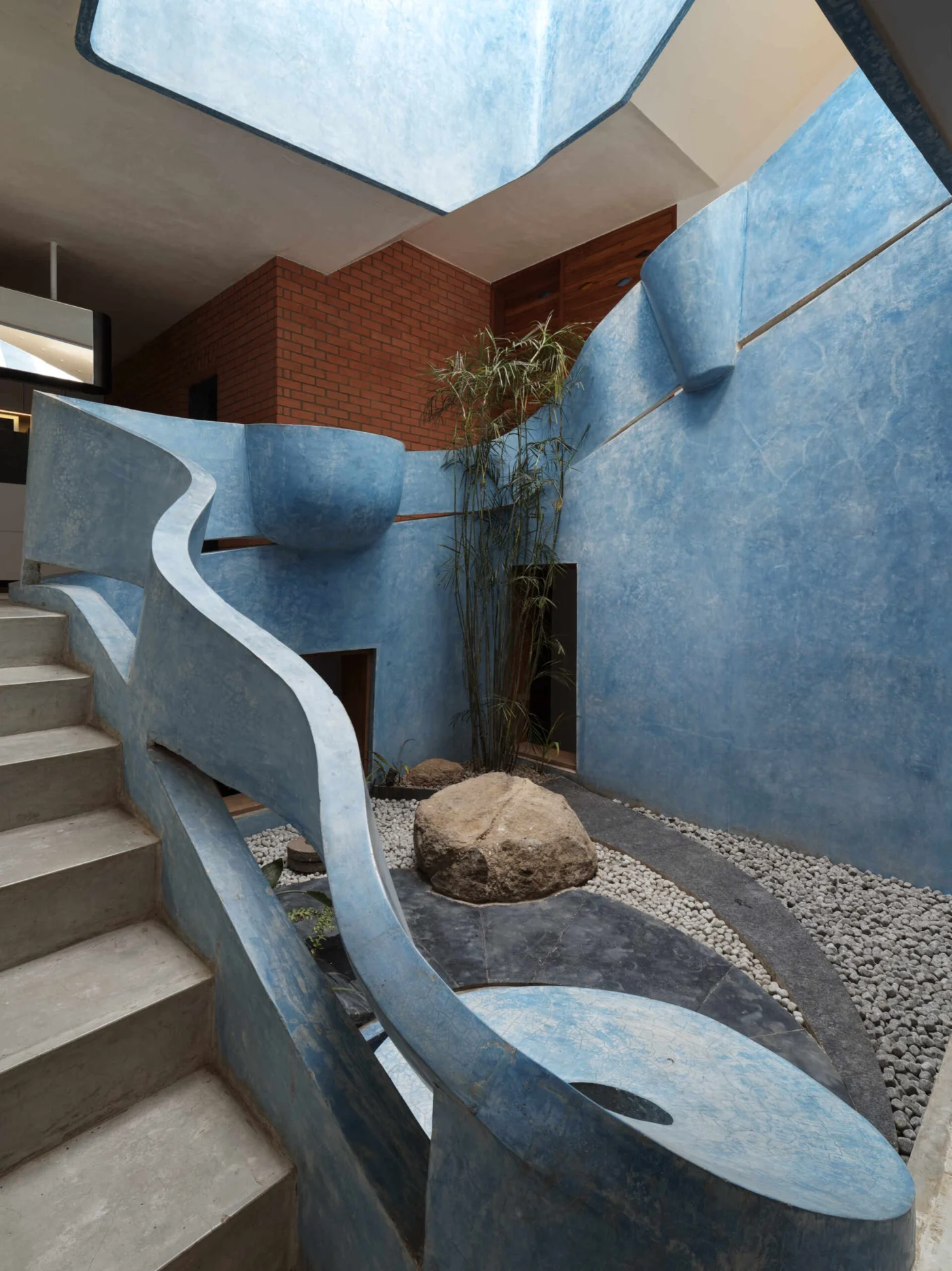 Curved staircase rising through a courtyard to the upper levels