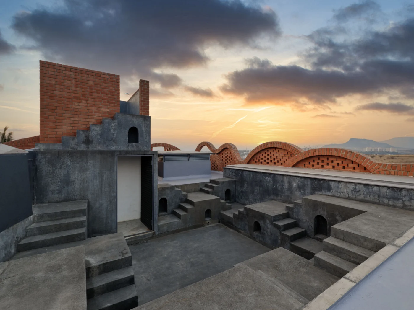 Rooftop with several levels joined by stairs at sunset