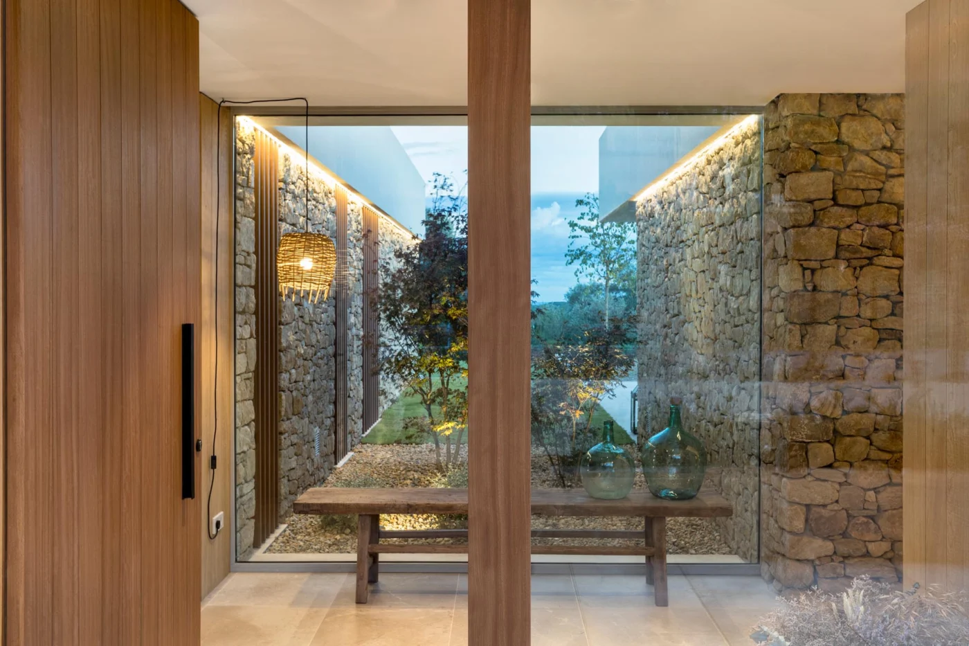 Entryway with a large window and stone walls continuing inside